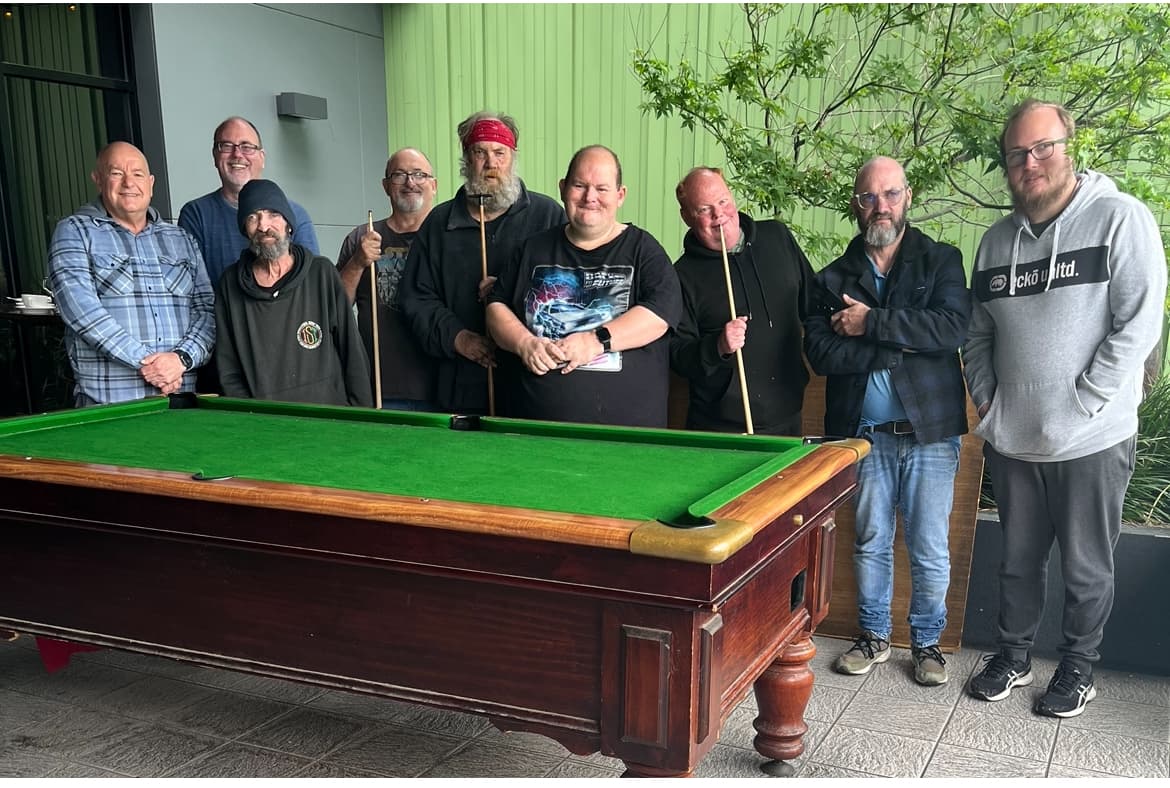 Group of men talking and laughing over coffee